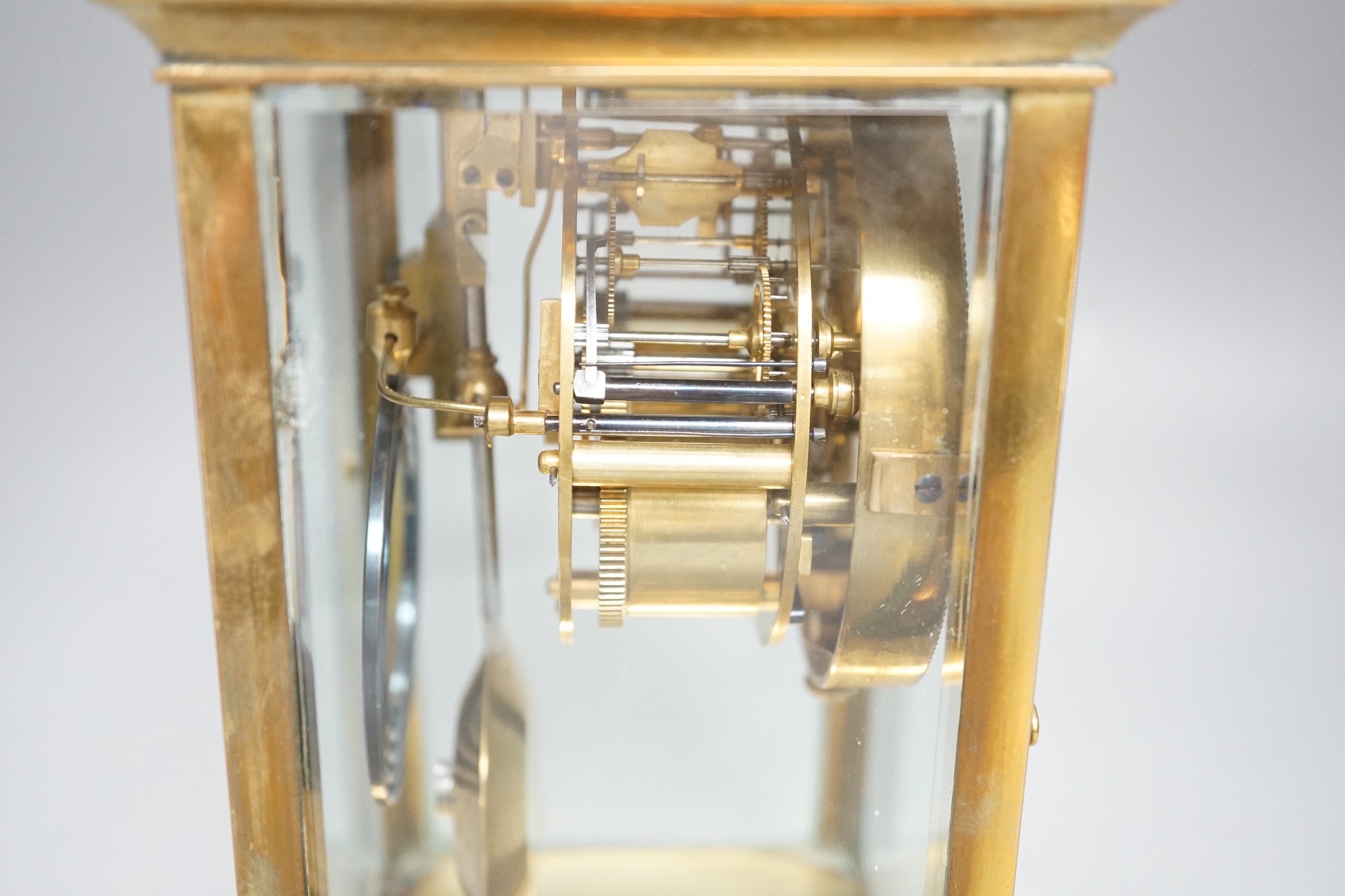 A French brass four glass mantel clock, 23cms high